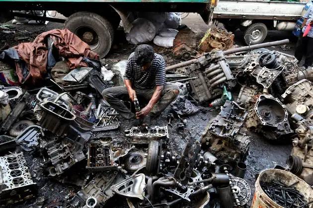 A man reparing some vehicle parts